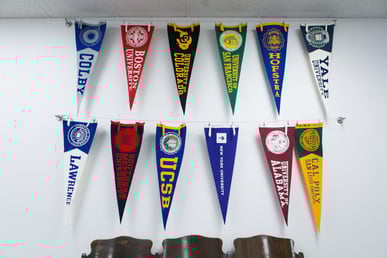 College pennant flags hanging from wall. College pennant flags hanging from wall.