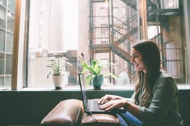 Collegewise counselor writing blog post in office